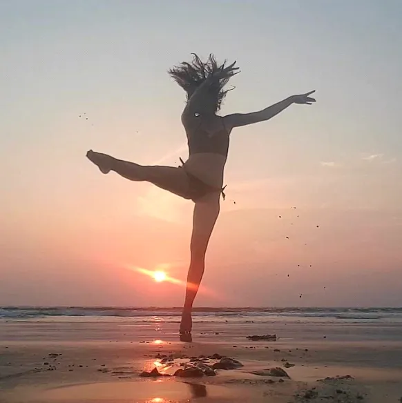 Pauline Zimnoch on the beach at sunset